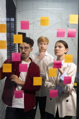 medium-shot-colleagues-thinking-with-post-its (1)